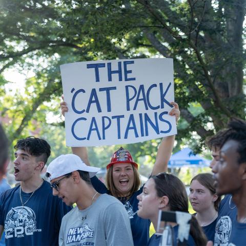 Student holding up sign that reads, "The Cat Pack Captains".