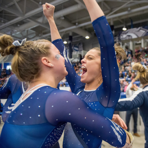 UNH gymnasts celebrating a win