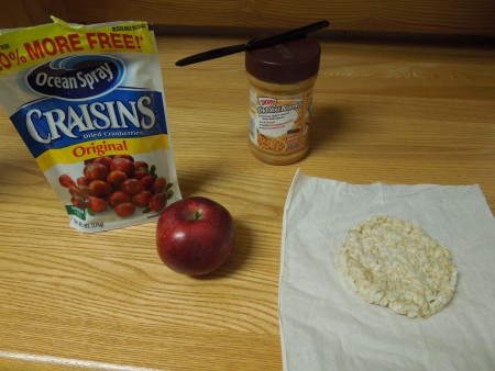 Craisins, an apple, peanut butter and a rice cracker