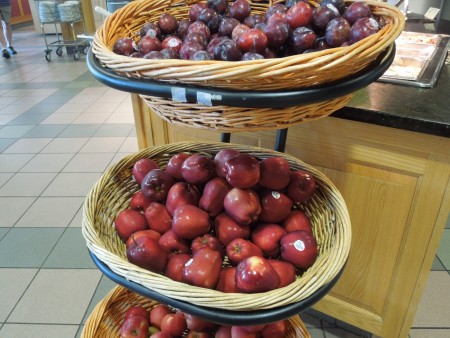baskets of apples and plums at a UNH dining hall