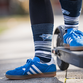 Close up view of feet wearing UNH Wildcat socks