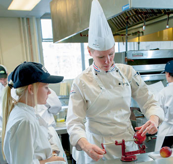 Dietetic technology student, Audra St. Hilaire from Merrimac, Mass., attends closely as Chef Julienne Guyette instructs.