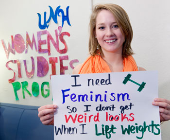 Stephanie Cuhn shows-off her sign she created at the Women's Studies Program's "Who Needs Feminism" campaign