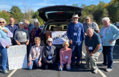 Group food drive photo in front of car