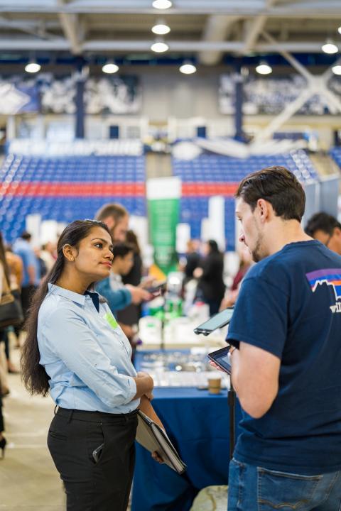 Image of student meeting with a visiting employer at the University of New Hampshire's Career and Internship Fair