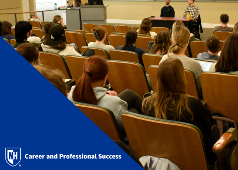 Students at a panel with CaPS logo in bottom left corner