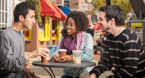 students drinking coffee in downtown Durham, NH