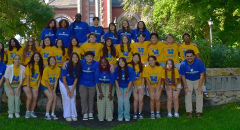 2024 CONNECT Participants wearing yellow shifts with blue writing, CONNECT mentors wearing blue shirts with the Beauregard Center logo on them, and Beauregard Center staff, standing in front of Thompson Hall