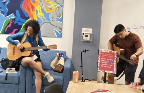 Students playing guitar in the Beauregard Center during our international student open house