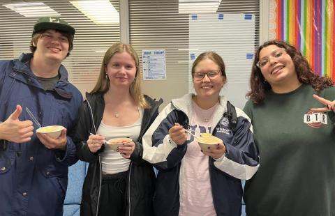 Four students holding traditional piragua 