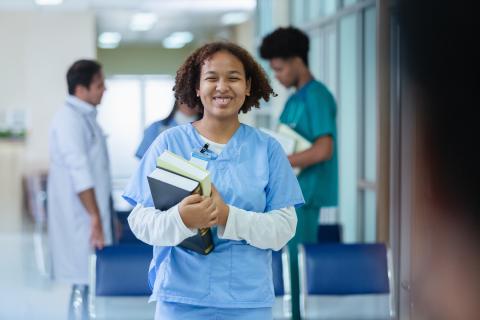 Nurse with textbook smiles