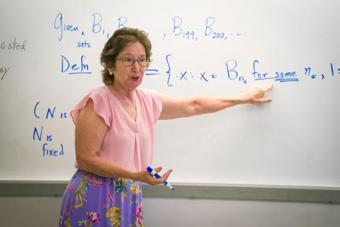 Professor stands at board