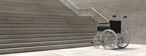 Wheelchair sits in front of flight of stairs