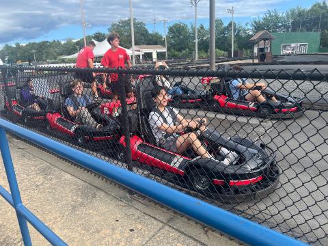 Students in go carts at a go cart cart center.
