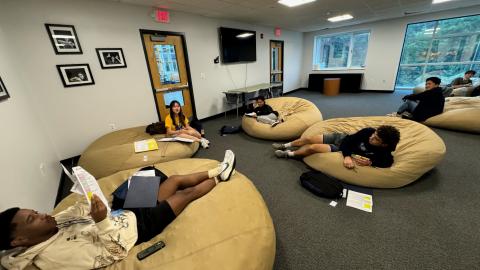Students participating in mentor-mentee time during the CONNECT program. Sitting on bean bags.
