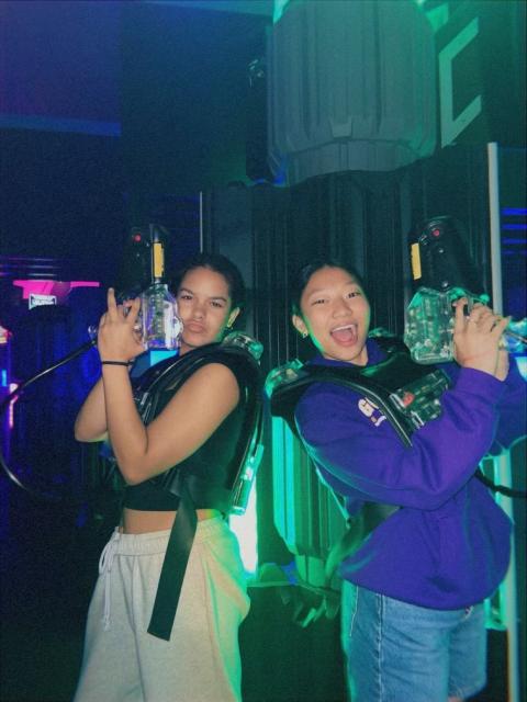Students playing laser tag holding laser guns. 