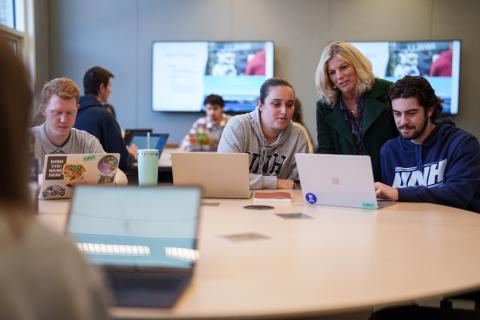 Students working with an instructor in class.