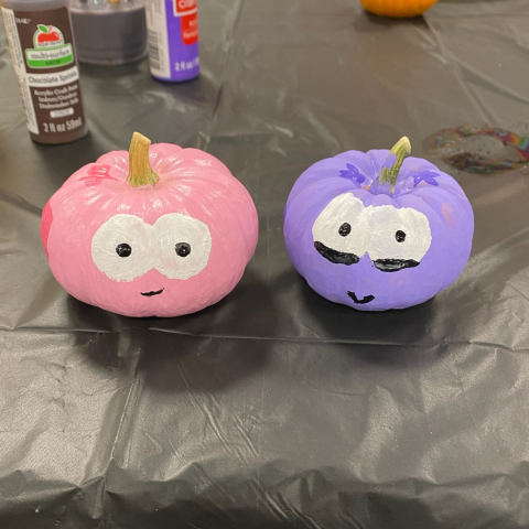 Two painted pumpkins at a Clocked Out event