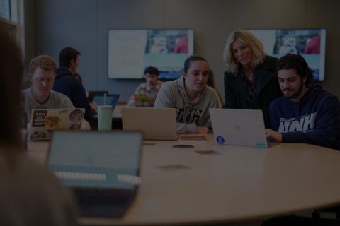 Students working with an instructor in class.
