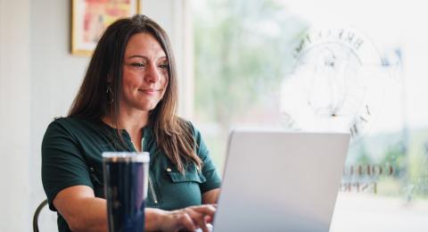Student at a coffee shop doing coursework online