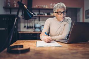 Woman with laptop taking online class 