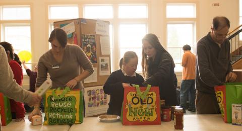 students packing bags of food