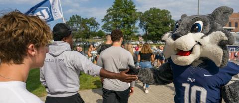 school mascot giving high fives