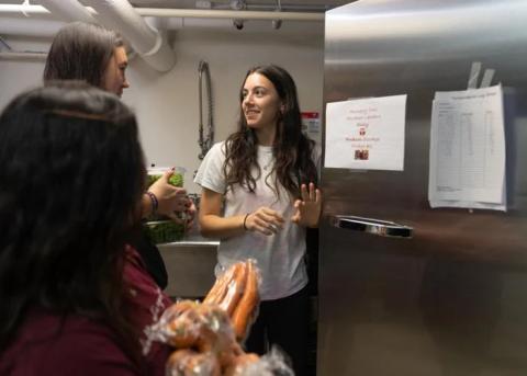 Students standing in front of fridge