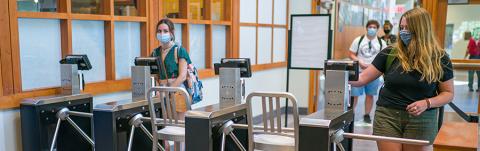 Students entering Holloway Commons at hand scanners