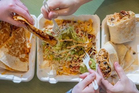 People sharing food from Serrano's