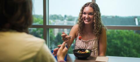 Summer at Holloway Commons - students eating a table