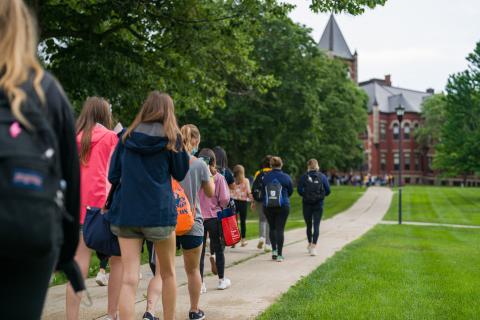 Group of students walking toward Thompson Hall