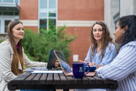 Students sitting at a picnic table