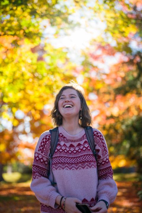 Student laughing in autumn scene