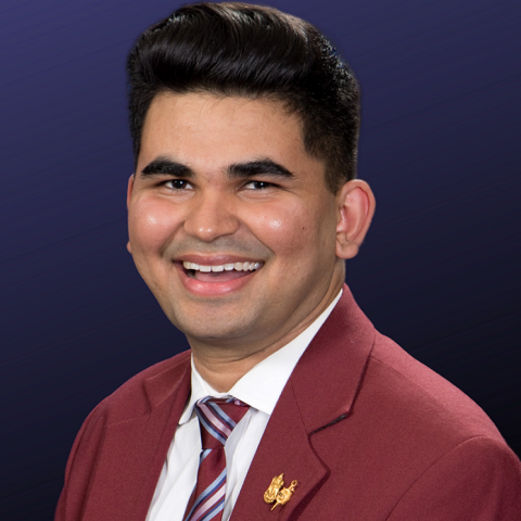 Headshot of Yashwant Prakash Vyas in maroon jacket, striped tie, and white shirt. 