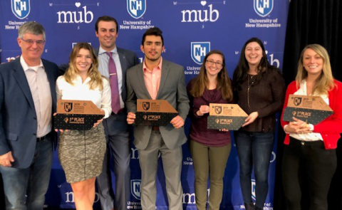 students holding awards