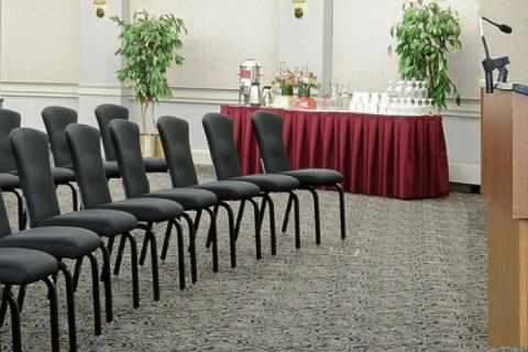 podium and chairs in meeting room setting