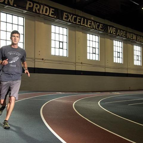 Student running on the Paul Sweet Oval track