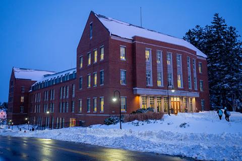 Students walk towards a hall through the snow