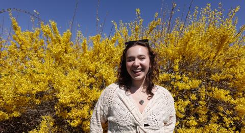 Woman in front of flowers
