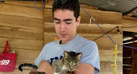 College student holding cat
