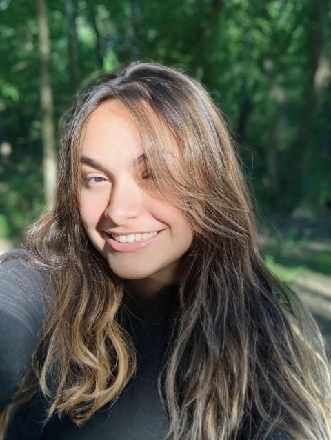 woman with brown hair smiles at camera