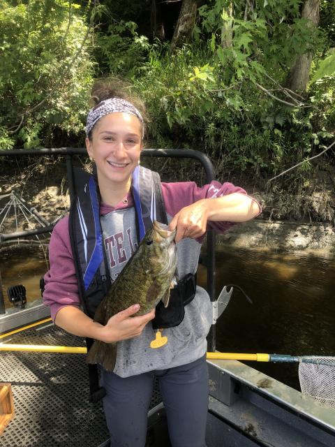Young woman holding a fish