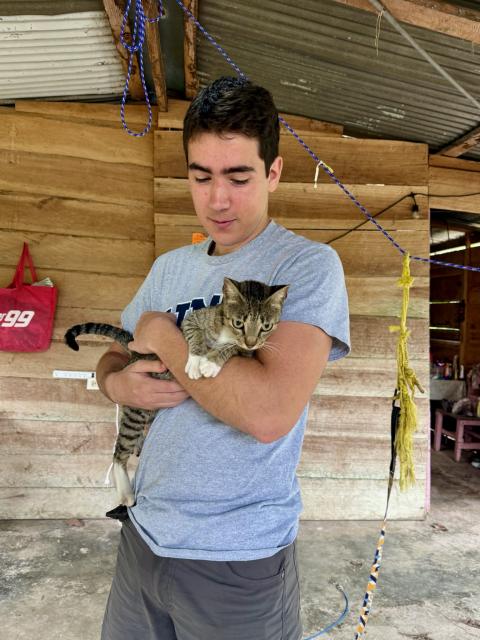 College student holding cat