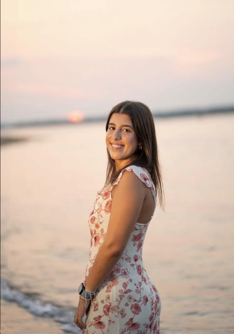 Young woman on the beach at sunset