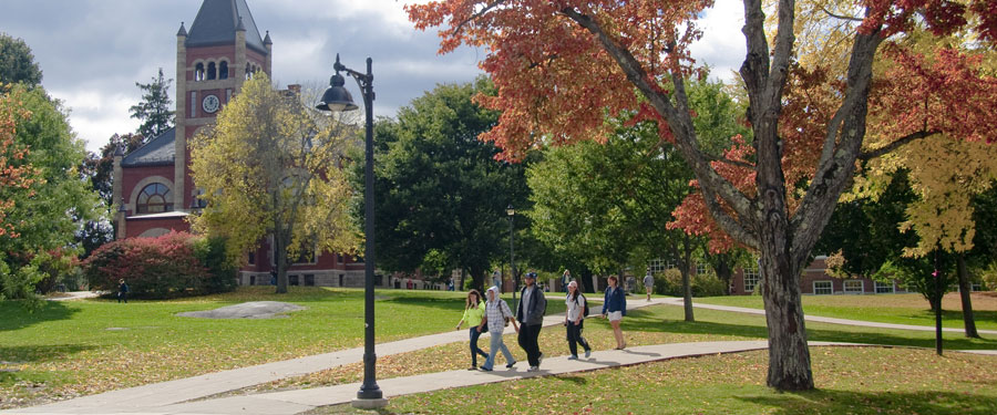 view of Thompson Hall with students in Autumn