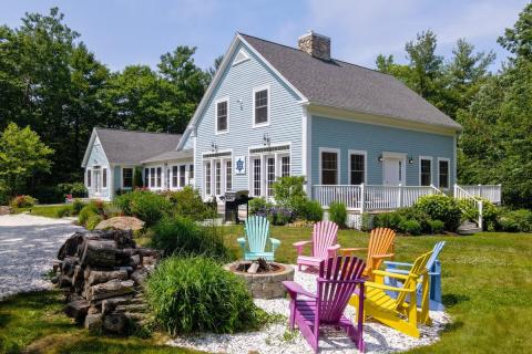blue house with Adirondack chairs