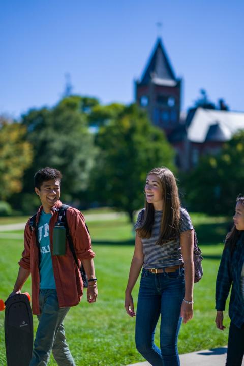 3 students walking outside