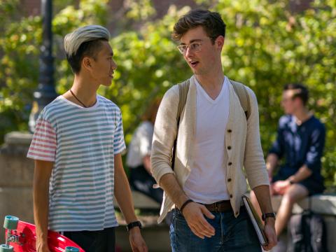 two people talking with skateboard unh campus