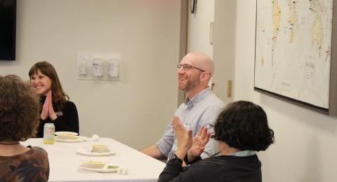 2023 Faculty Award Winner Alex Holzneinkemper sitting at a table at his award ceremony